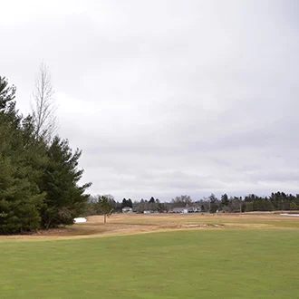 Golf course fairway with trees on left