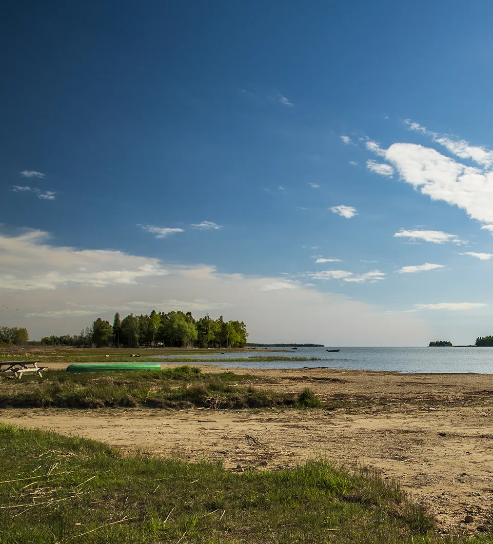 Scenic view of a beach with a lake in the background