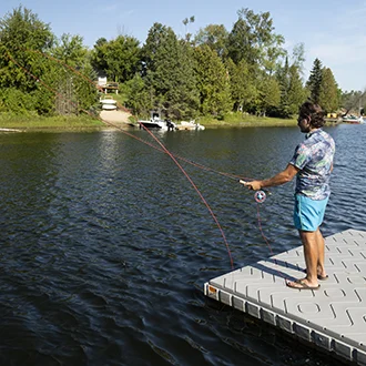 Person fishing off a dock
